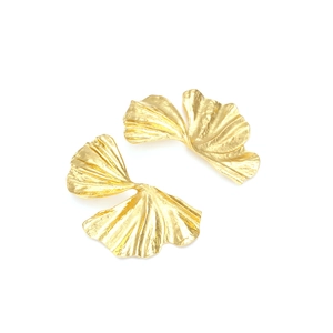 Detailed view of golden ginkgo leaf earrings with textured metallic surface and 3D design