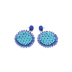 Detailed macro view of bohemian hand-woven raffia sunflower earrings in deep blue shades
