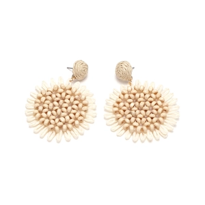 Close-up of handmade raffia sunflower earrings featuring central beads and cream petals
