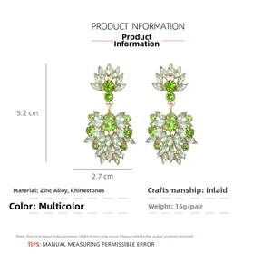 Detailed view of floral drop earrings featuring green rhinestones and alloy setting
