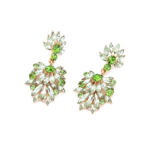 Detailed macro of crystal flower earrings with green rhinestones in golden setting