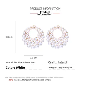 Detailed view of round faux pearl earrings with size measurements of 3.8cm diameter