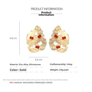 Detailed view of geometric gold earrings with red rhinestones and 4.8cm size mark