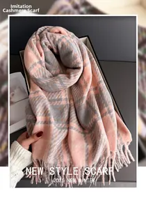 Détail d'une écharpe à carreaux rose et gris en imitation cachemire avec franges en coffret