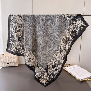 Elegant silk-like square scarf with black and white floral prints and yellow accents