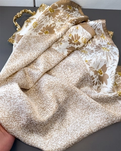 Detailed macro of vintage floral silk scarf texture with daisy prints and rolled edges