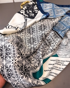 Detail of silk-feel scarf featuring navy blue zebra print and geometric patterns