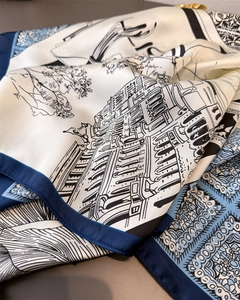 Macro detail of silk scarf featuring architectural prints and floral geometric edges