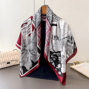 Detail of silk-like scarf featuring vintage floral prints and artistic patterns
