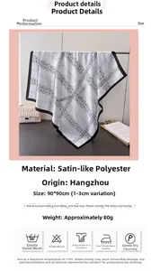 Detail view of large satin scarf with geometric floral print and care label instructions