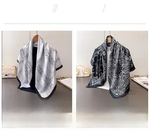 Detail view of white geometric and black paisley printed faux silk square scarves on hangers