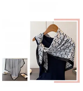 Close-up of geometric pattern satin silk scarf with elegant black and white print design