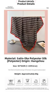 Detail showing the brown geometric pattern and red border of this large satin silk scarf