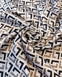 Detailed view of satin fabric texture with grey geometric pattern in a spiral rose fold