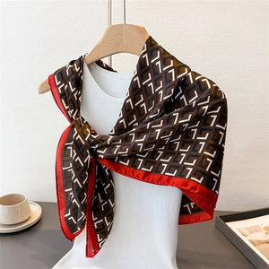 Vintage geometric print silk satin square scarf with red border on mannequin hanger