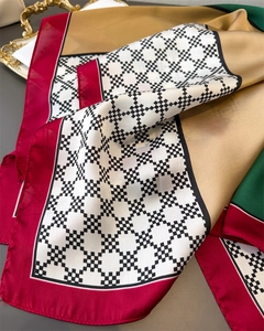 Detail of satin silk scarf featuring vintage geometric patterns and color-block design