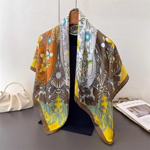 Retro bohemian four-leaf clover print silk scarf draped on a wooden hanger gracefully