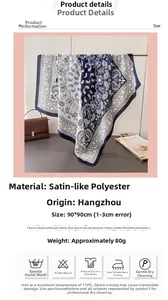 Detail of 90cm paisley satin scarf styled with a leather bag for elegant lifestyle
