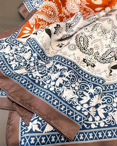 Detailed view of paisley silk scarf with satin sheen and premium stitched edges