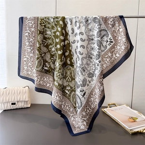 Silk satin square scarf featuring emerald paisley print and luxury geometric patterns