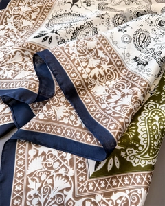 Close-up of paisley pattern satin scarf showing detailed stitching and silky texture