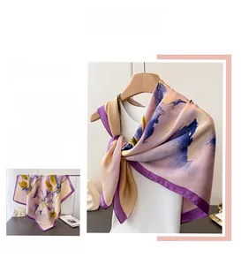 Detail view showing abstract floral patterns and high-quality stitching on purple silk scarf