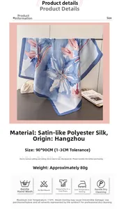 Detail of 90x90cm floral satin scarf with blue flower pattern and soft silk-like texture