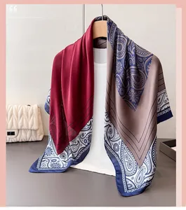 Detail of paisley satin scarf with navy blue edges and silk-like glossy texture