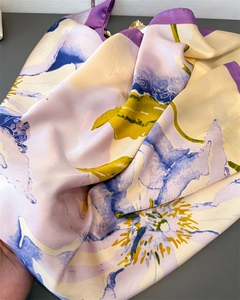 Detail of elegant floral print silk satin scarf showing texture and glossy finish