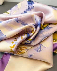Close-up of luxury silk scarf showing abstract floral print and satin texture
