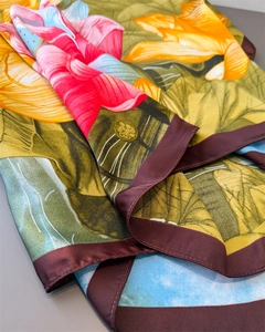 Close-up of ink-style lotus print on silky satin scarf showing fine fabric texture