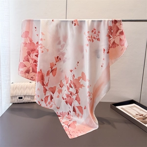 Elegant silk-like scarf with ink-style pink ginkgo leaf prints hanging on a minimalist stand