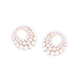 Detail of round pearl cluster earrings with white pearls on a gold metal base