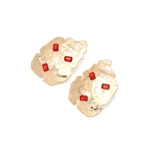 Irregular hammered gold earrings with inset red baguette gems for a retro geometric look