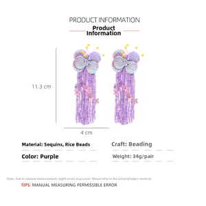 Detail view of purple beaded butterfly earrings with long tassels and size dimensions
