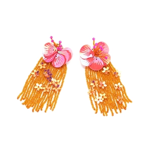 Detail of pink sequin flower earrings with orange glass beaded tassels and gold accents