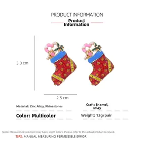 Detail view of a Christmas stocking brooch with red enamel, yellow rhinestones and dimensions