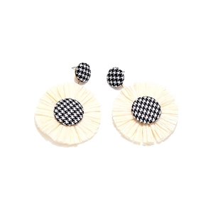 Handwoven raffia flower earrings with houndstooth button accents in black and white