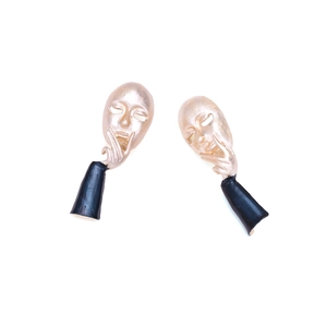 Artistic golden abstract face mask earrings with hand chin resting in surrealist style