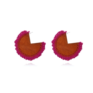 Handmade bohemian geometric wood earrings with vibrant magenta fringe and crochet detailing