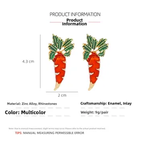 Detail view of carrot enamel earrings with dimensions 4.3cm by 2cm and rhinestone accents