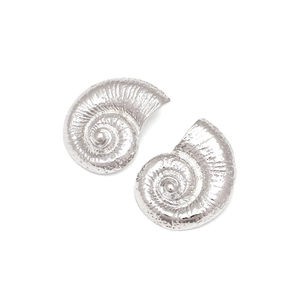 Macro detail of silver alloy conch shell earrings with realistic spiral texture and luster
