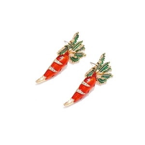 Detailed view of carrot stud earrings with orange enamel and sparkling rhinestones