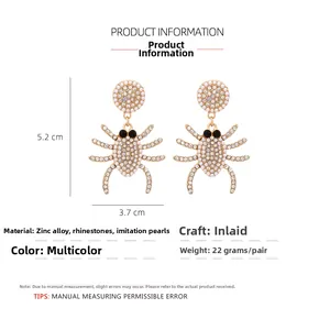 Detailed view of rhinestone spider earrings with faux pearls and dimensions 5.2cm by 3.7cm