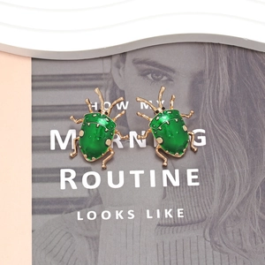 Cute green enamel beetle stud earrings with gold plating for a vintage insect jewelry look