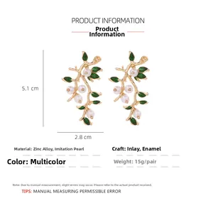 Detailed size specifications of vine-shaped gold alloy earrings with pearls and green leaves