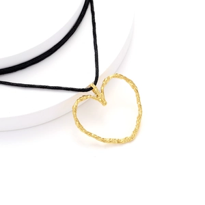 Minimalist gold heart pendant necklace with lava texture on black woven cord