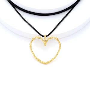 Gold hollow heart pendant necklace with textured rope detail on black cord minimalist style