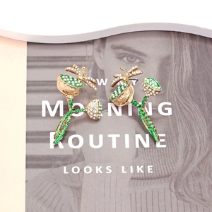 Exquisite lotus dragonfly drop earrings with sparkling rhinestones and pearls on a magazine