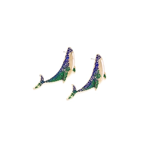 Golden whale stud earrings with blue spotted enamel finish on a clean white background